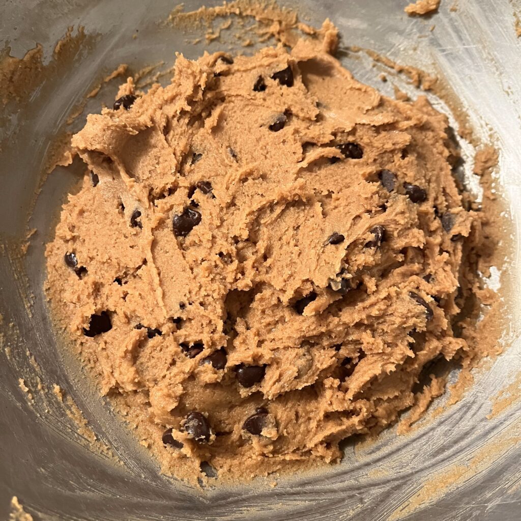 Cookie dough in a metal bowl.