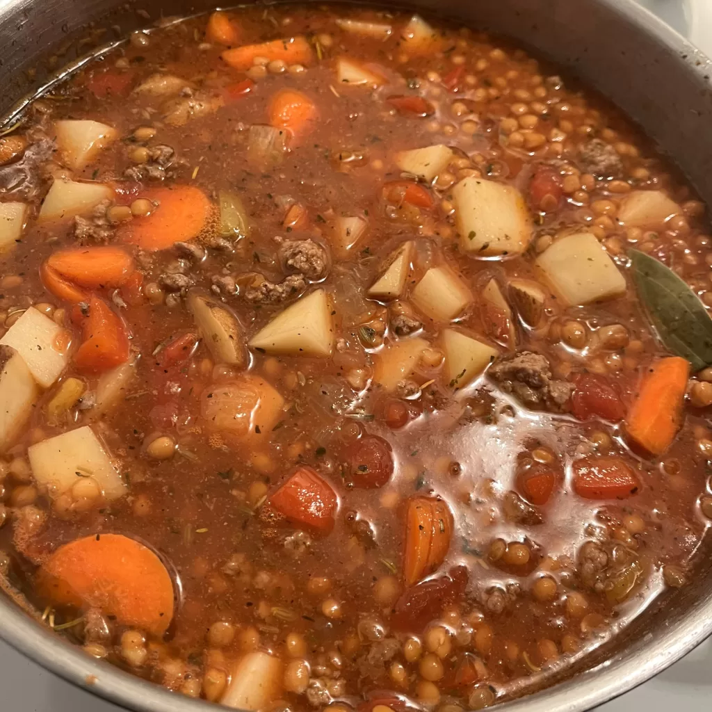 Italian Sausage Soup cooking in a pot.