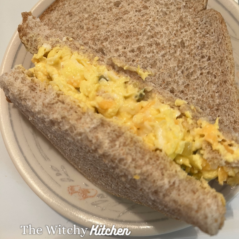 Egg Salad Sandwich on a plate by The Witchy Kitchen.