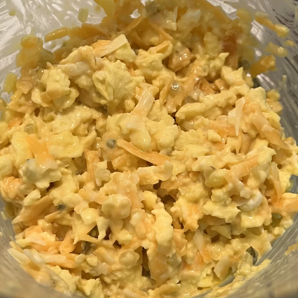 Egg salad in a glass measuring cup.