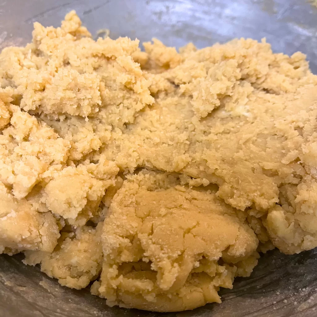 Cookie dough in a metal bowl.